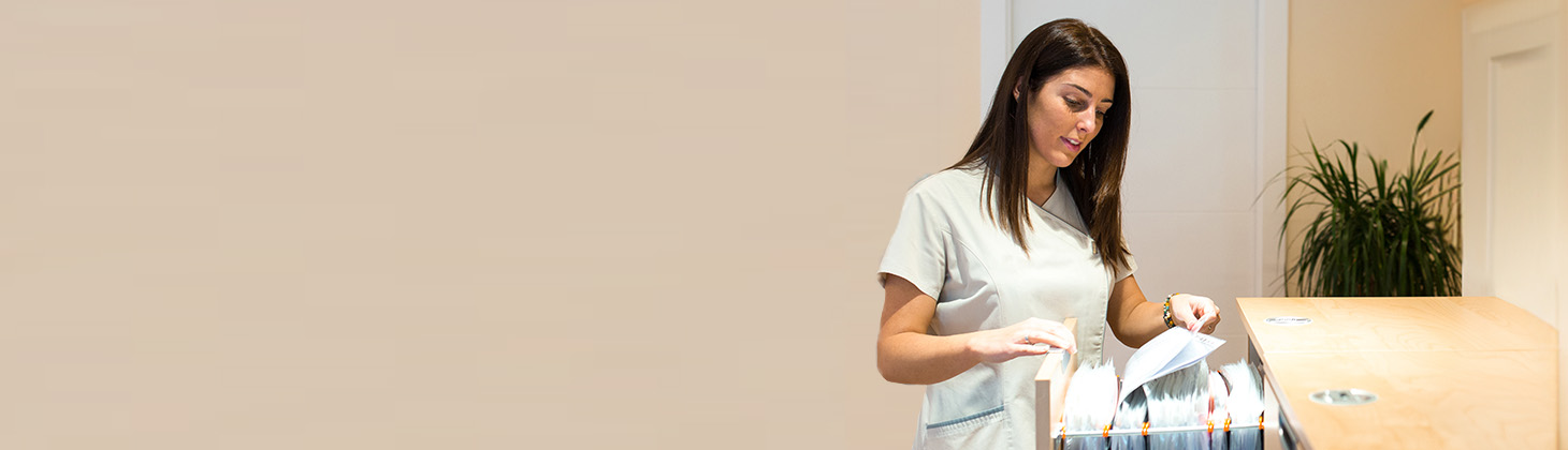 Woman pulling folder out of filing cabinet