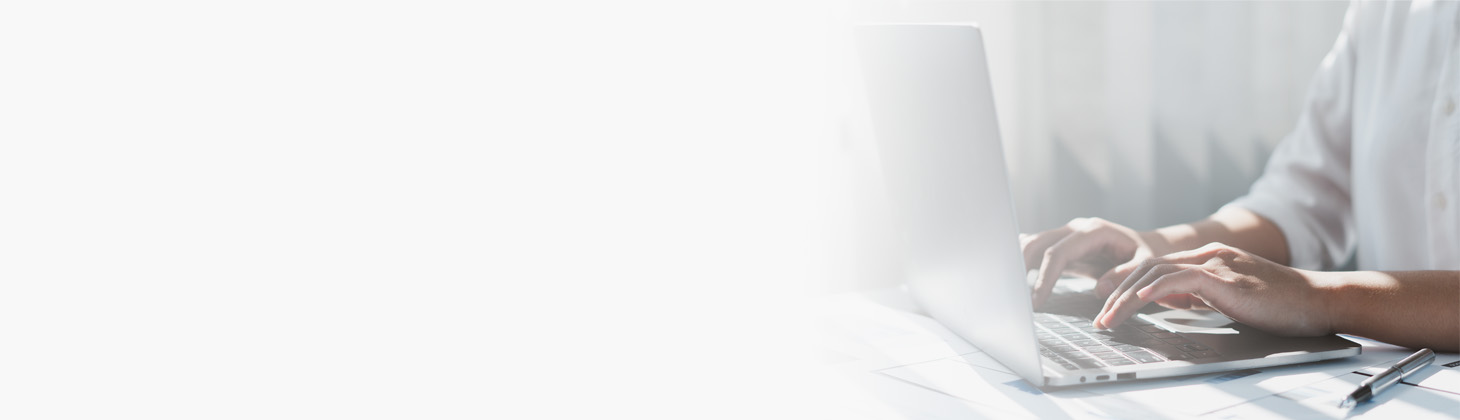 Hands typing on a laptop keyboard
