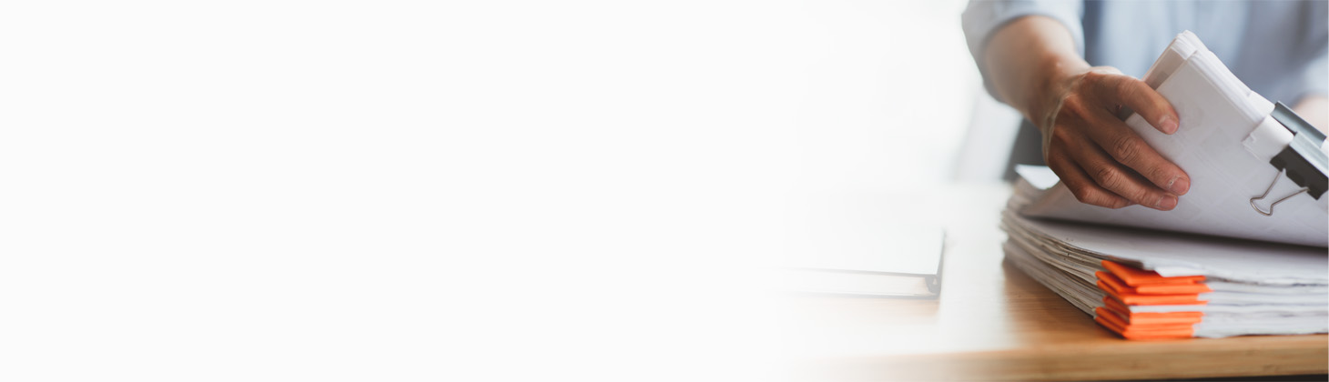 A chiropractor holding a stack of papers