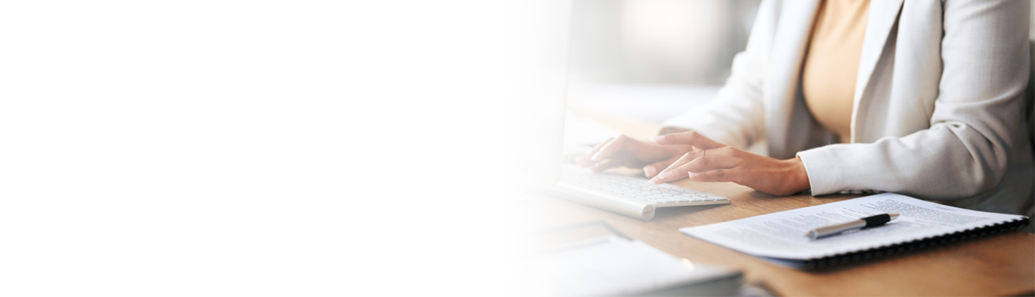 A person typing on a computer keyboard.