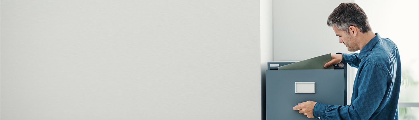 Man opening a file cabinet