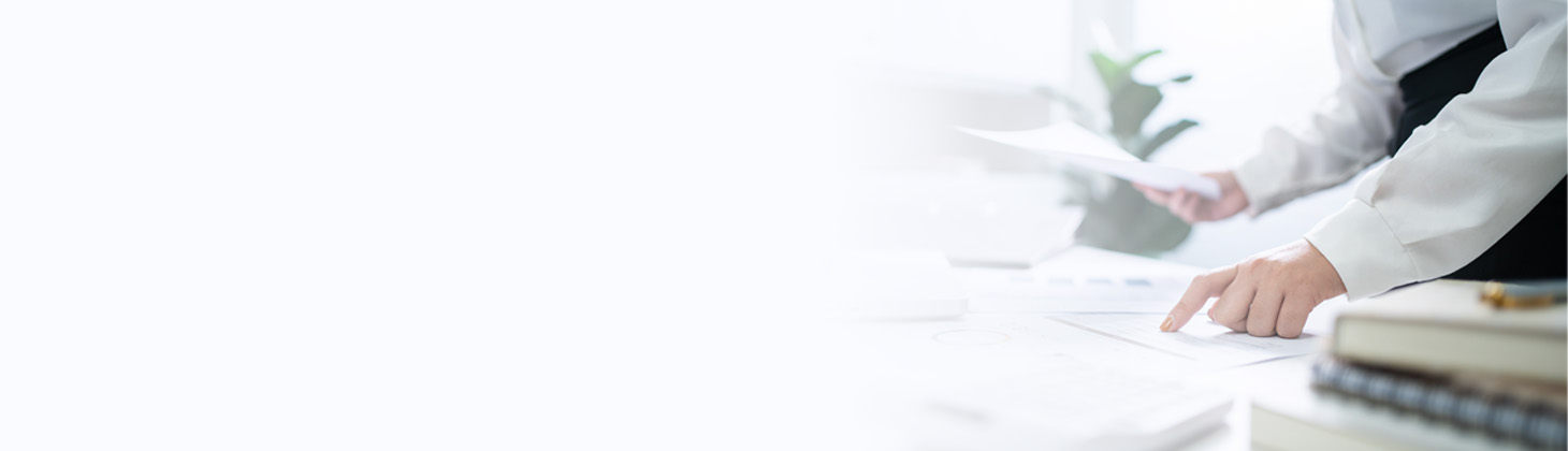 A chiropractor types on a laptop computer.