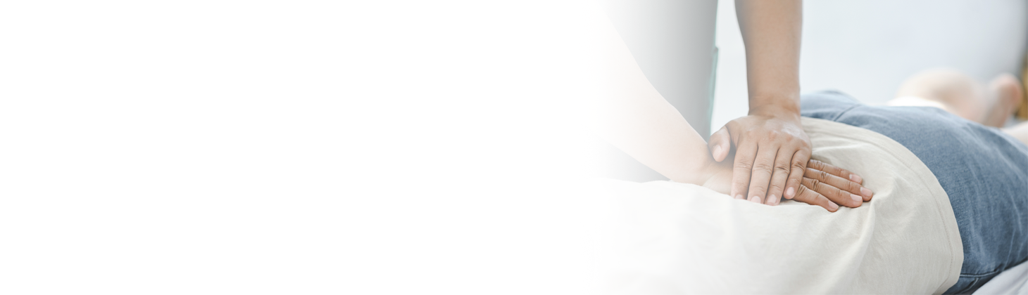 A chiropractor adjusts a patient.