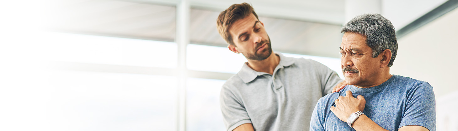 Male doctor working on male patient