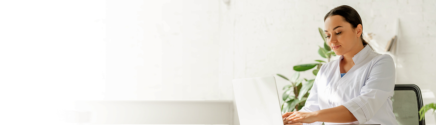 A female DC types patient notes into her laptop.